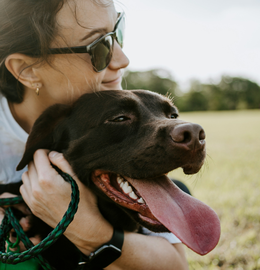 Woman caring for her dog, highlighting UrgentPaws urgent vet care for pet lacerations, cuts, and wounds in dogs and cats.